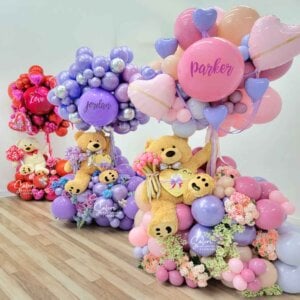 3 Teddy bear balloon arrangements in pastel colors. Bear is holding helium balloons. Oregon Balloon decor