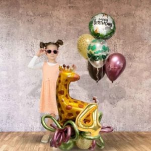 A little girl standing next to a Safari-themed balloon bouquet with balloon numbers. Oregon Balloon decor