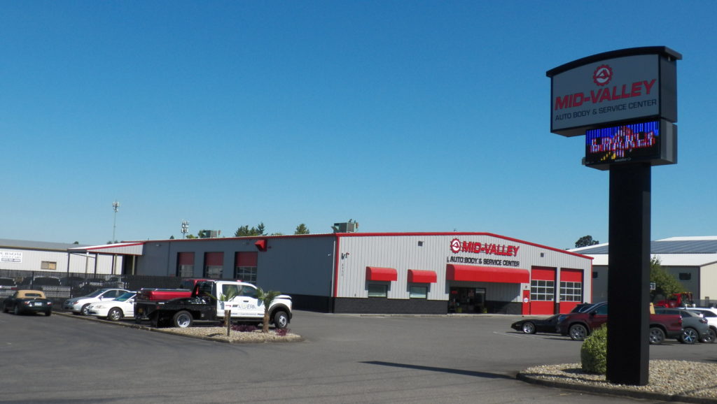 Mid-Valley Autobody and Service Center shot from the outside to show their parking lot and facility