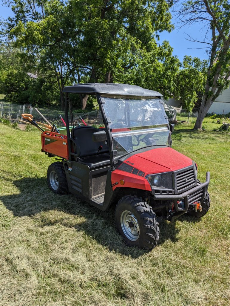 Image of UTV parked on a grassy lawn.