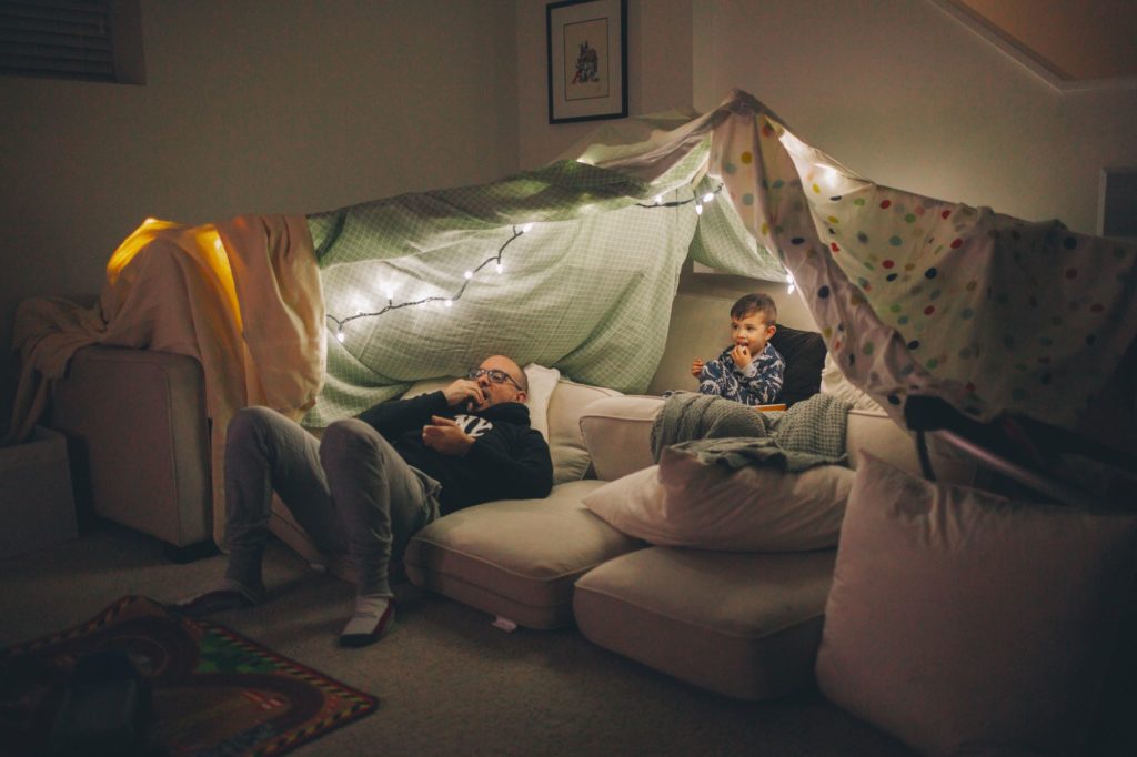 Blanket fort with dad and son