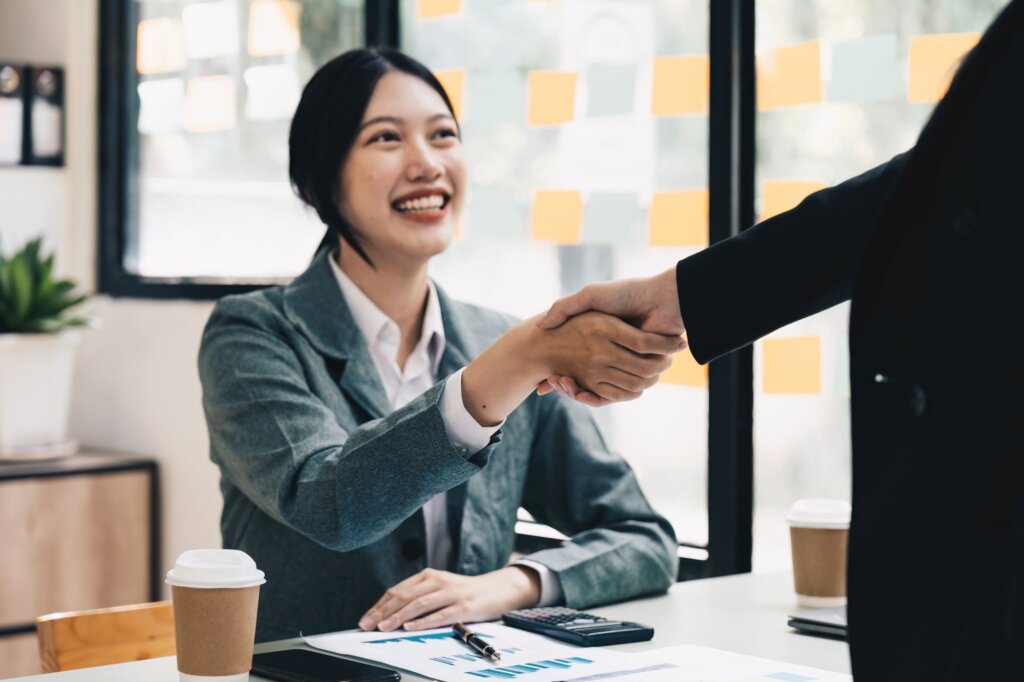 Businesswoman shaking hands with another person