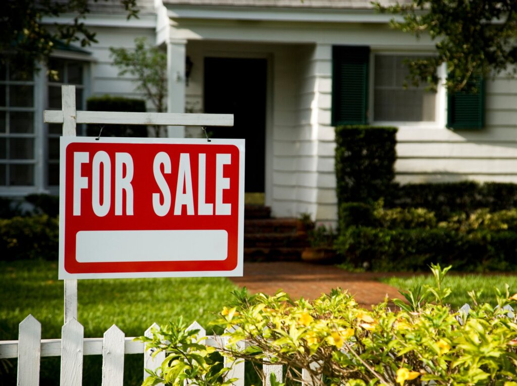 For sale sign in front of home