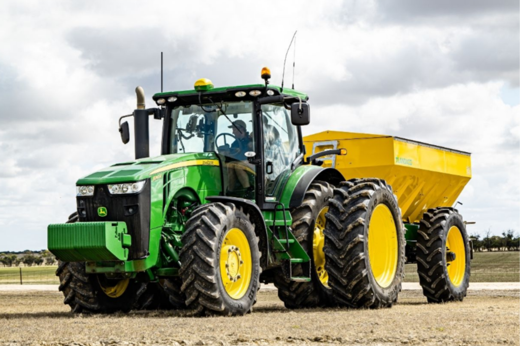 Green tractor with protective agricultural coating for farm equipment.