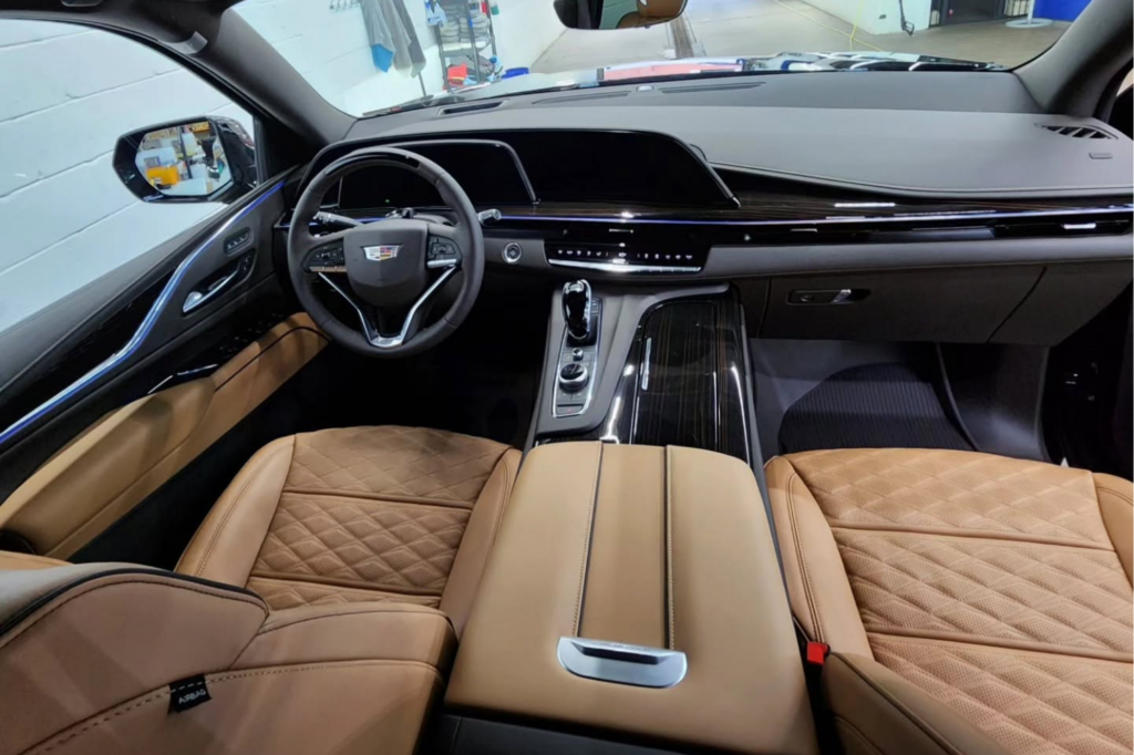 Detailed Cadillac interior with clean leather seats and surfaces.
