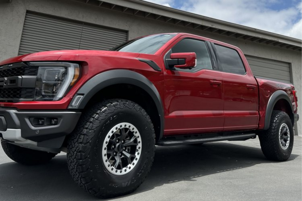 Red Ford with paint protection film preserving the finish.