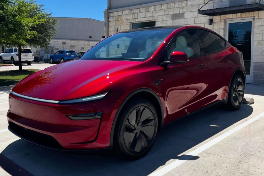 Red Tesla with paint protection film protecting the exterior finish.