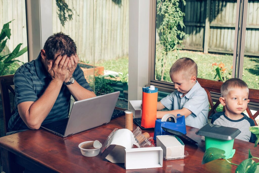Man stressed with two young kids