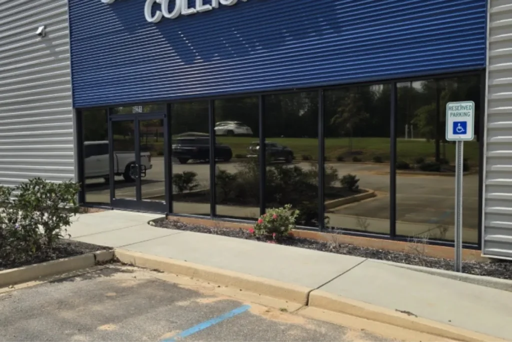 Storefront building exterior featuring tinted dark glass windows with commercial window film.