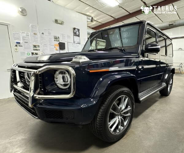 Mercedes-Benz G-Class SUV with a chrome brush guard inside an auto detailing