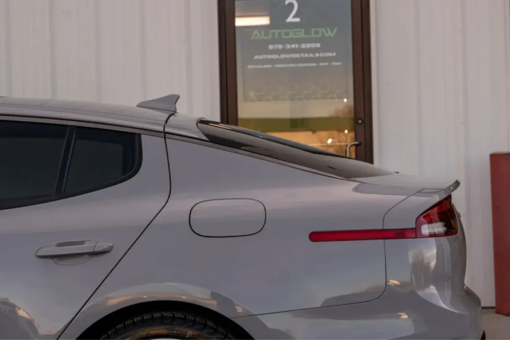Side profile of a gray car displaying a flawless clear coat following paint correction.