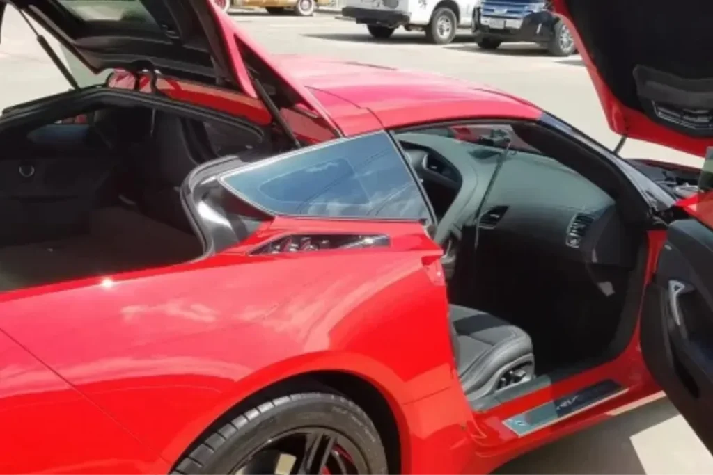 Bright red sports car with open doors and trunk during mobile detailing in Fort Worth, TX.