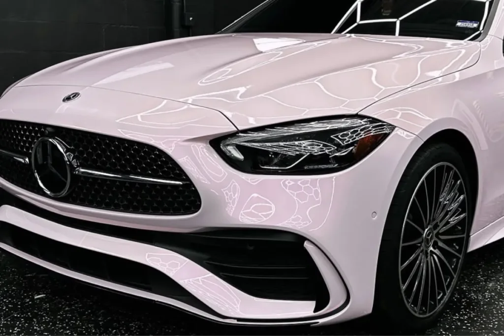 Glossy light pink Mercedes-Benz inside a detail shop after paint correction in Tampa FL.