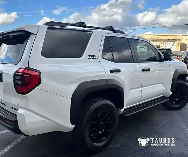 view of the white Toyota 4Runner TRD Off-Road parked outside an auto detailing shop