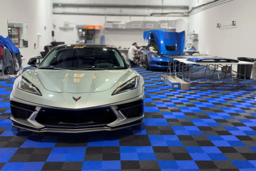 Silver Corvette parked in a garage for paint protection film in Sarasota FL.