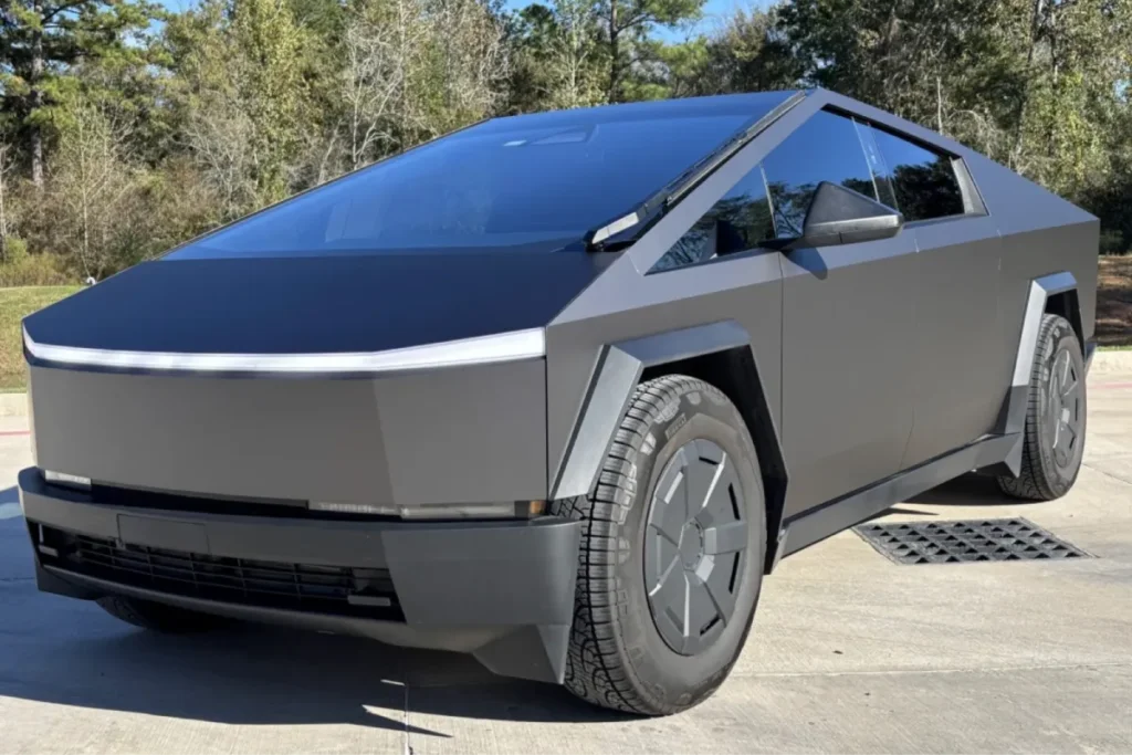 Matte black Tesla Cybtruck with custom vinyl wraps parked outdoors.