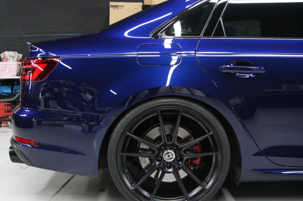 Blue car with a glossy finish after paint correction.